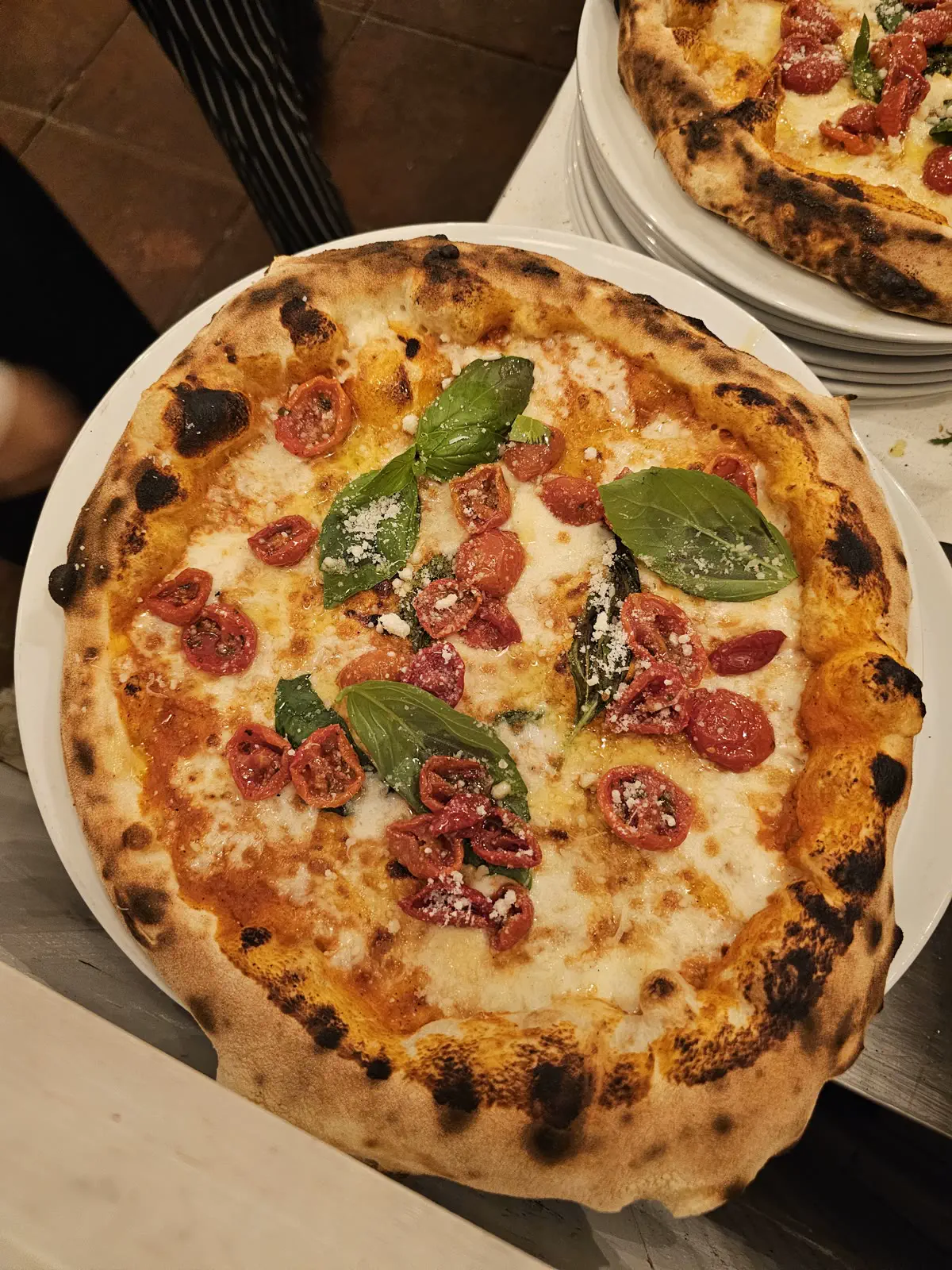 Margherita pizza with basil and cherry tomatoes from Josè's wood-fired oven